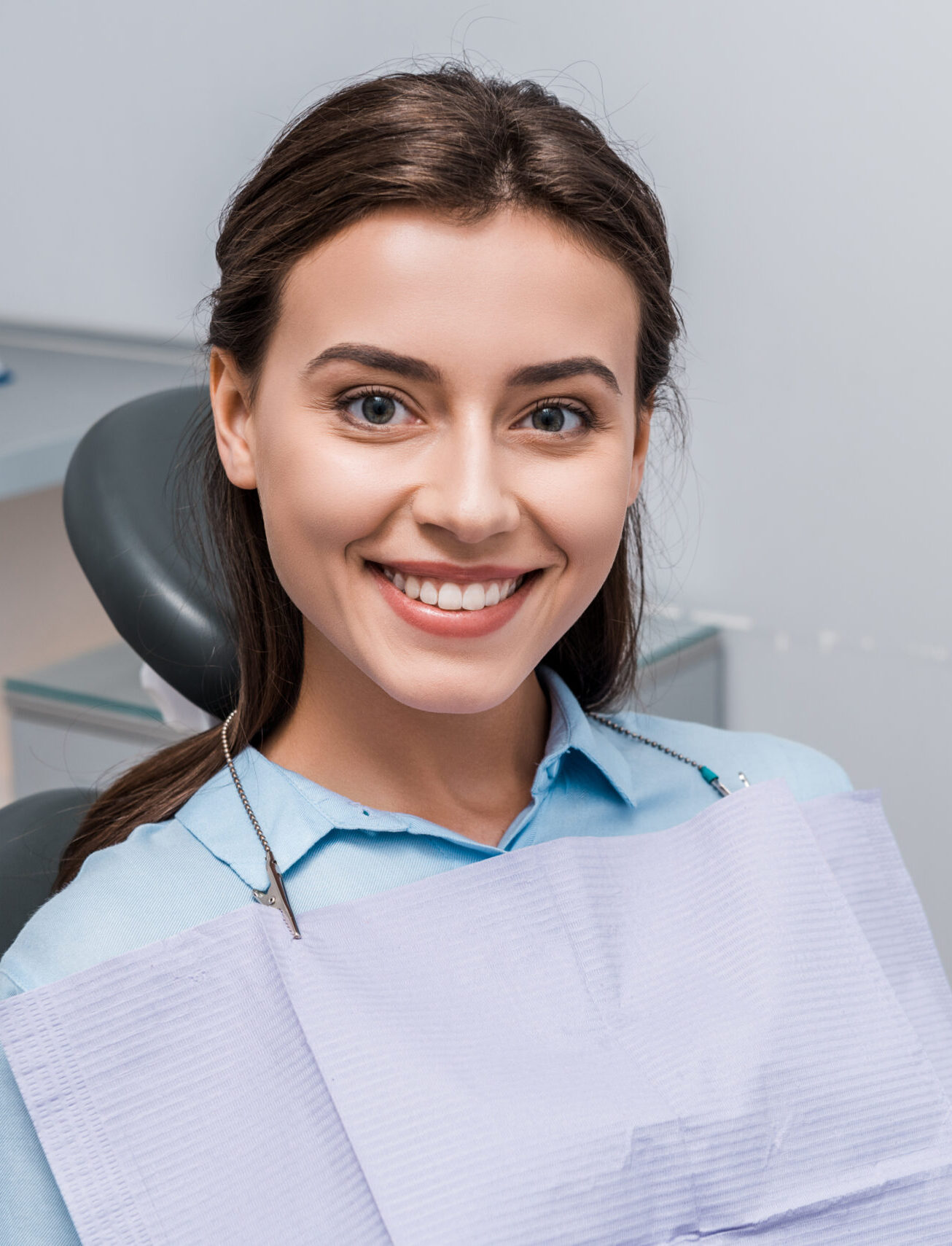 beautiful woman sitting and smiling in dental clinic
