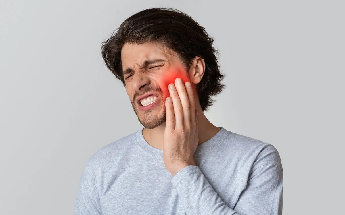 Dental care and health concept. Despaired man endure pain, empty space