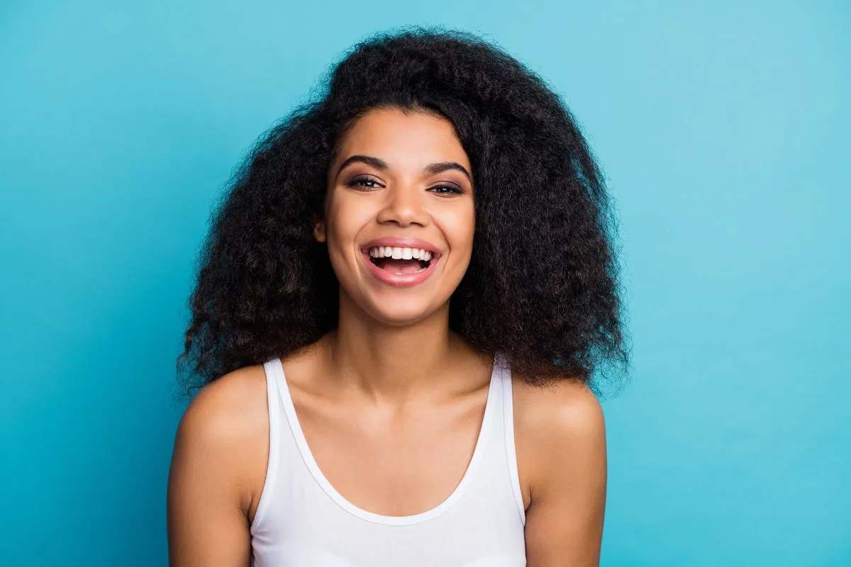 Close-up portrait of her she nice attractive lovely winsome lovable, cheerful cheery wavy-haired girl wearing modern fashionable makeover isolated over bright vivid shine vibrant blue color background