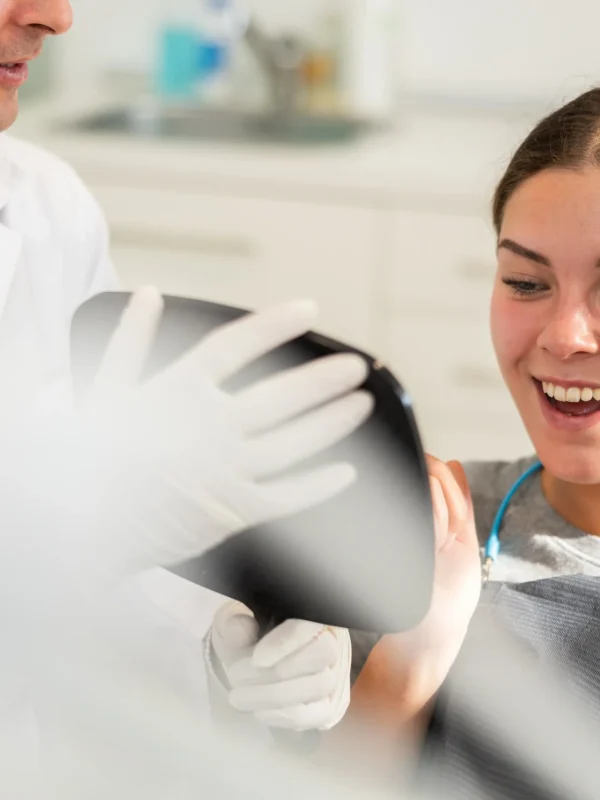 In dentists office, patient sits in dental chair