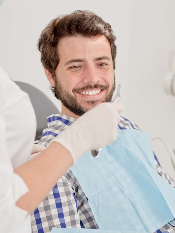 young man and woman in a dental examination at dentist