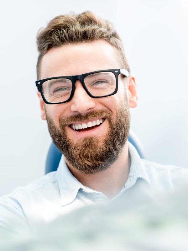 Handsome businessman with great smile sitting on the dental chair