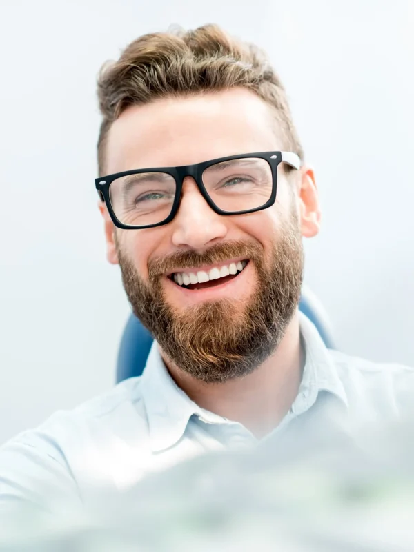 Handsome businessman with great smile sitting on the dental chair