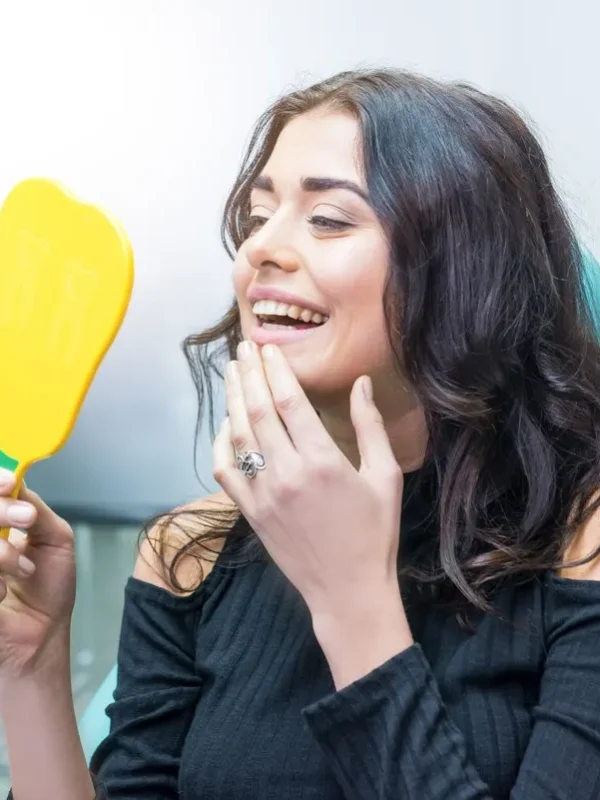 Woman looking at her teeth. Smiling lady at dentist office. Smile as a masterpiece.