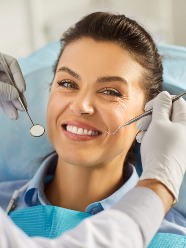 Dentist exam, teeth, gums, dental care exam, happy smiling woman healthy smile at doctor visit in clinic, demonstrating whitening teeth procedure result, satisfied with stomatology clinic service