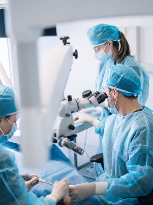 Dentist during a dental intervention with a patient. Dental clinic concept.