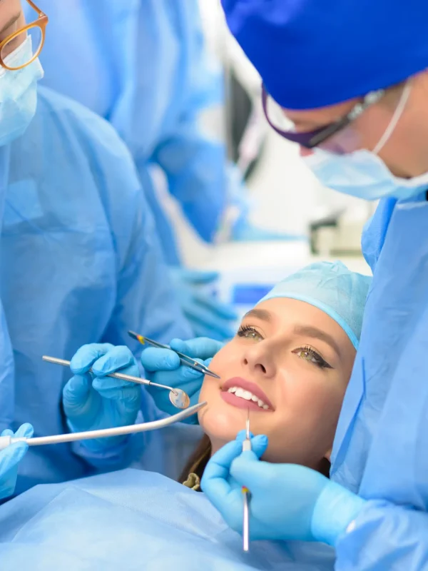 Dentist doctor and his team treating a patient at clinic