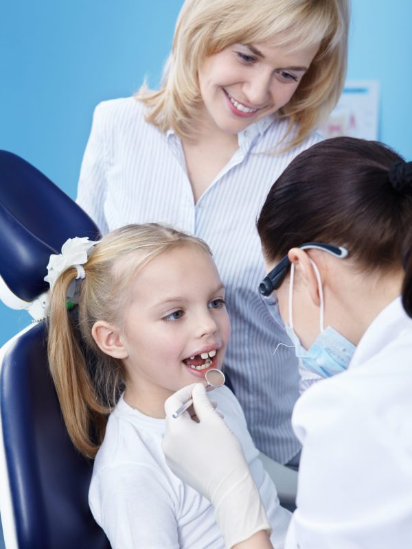 The dentist makes examination of the child