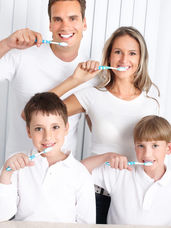 Happy family toothbrushing. Father, mother and children with toothbrushes.