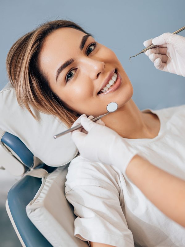 Professional doctor dentist examine and treat spoiled teeth with the use of special dental instruments, medical equipments.