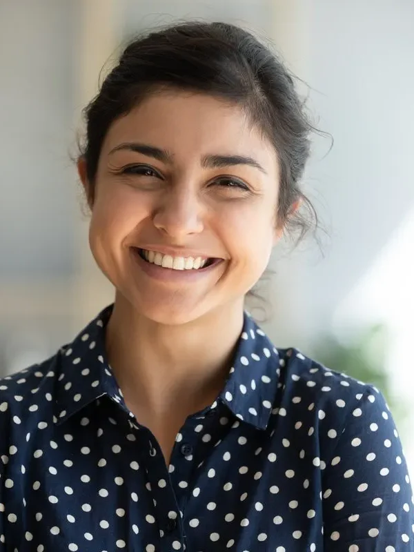 Cheerful beautiful indian girl student professional standing at home in office looking at camera, happy confident entrepreneur hindu lady laughing face posing alone, head shot close up view portrait