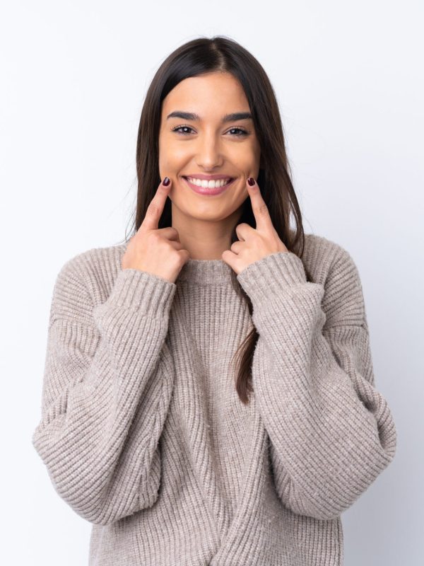 Young brunette woman over isolated white background smiling with a happy and pleasant expression