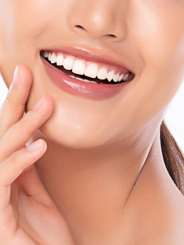 Beautiful smile young woman. White teeth on white background,