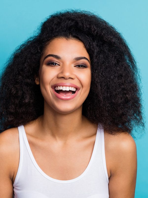 Close-up portrait of her she nice attractive lovely winsome lovable, cheerful cheery wavy-haired girl wearing modern fashionable makeover isolated over bright vivid shine vibrant blue color background