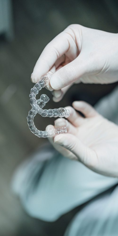 Dentist hands showing new dental aligners