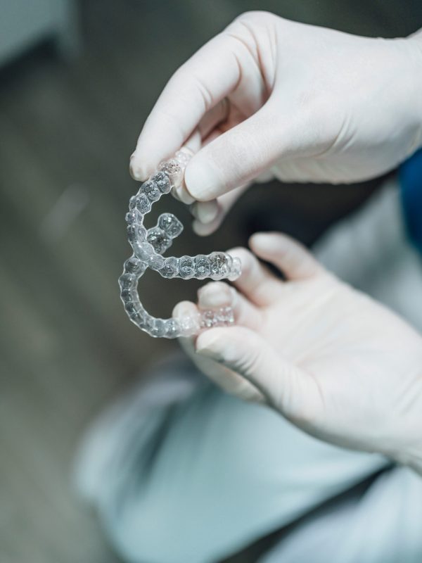 Dentist hands showing new dental aligners