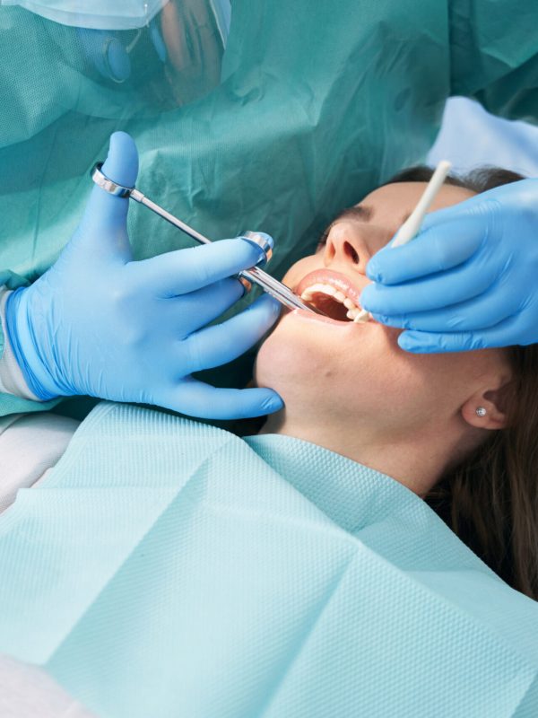 Woman receiving dental treatment in dentist office
