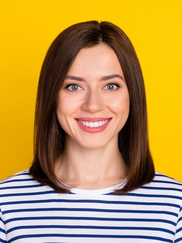 Photo of nice cute pretty woman bob hairstyle dressed striped t-shirt toothy smiling dental advert isolated on yellow color background.