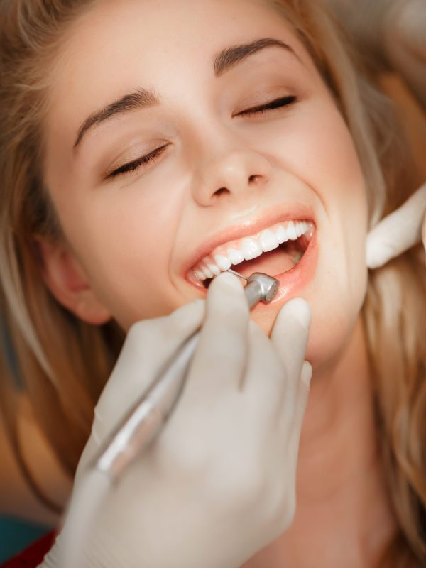 Dentist woman teeth whitening dental clinic