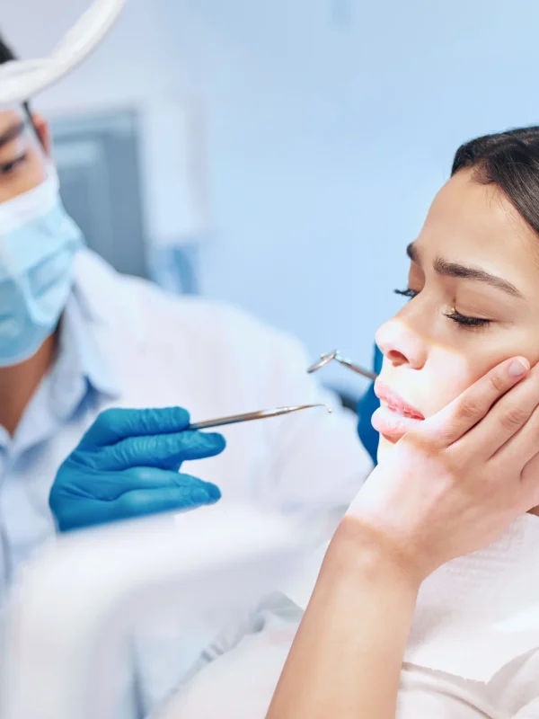 Dental, fear or woman with toothache in dentist consultation for mouth examination, gingivitis or bacteria. Tooth extraction, pain or cosmetic surgeon with tools for cavity, root canal or procedure.