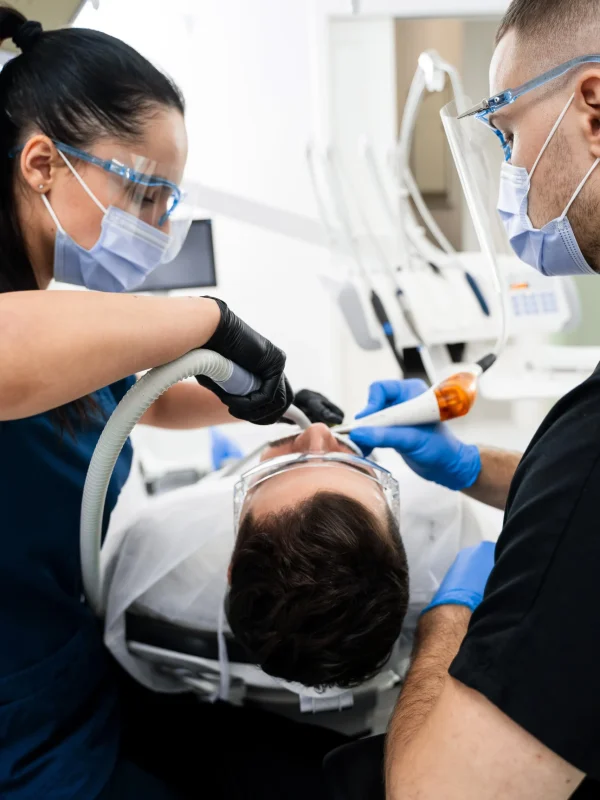 Oral surgery team performing tooth extraction procedure at Rivers Dentistry