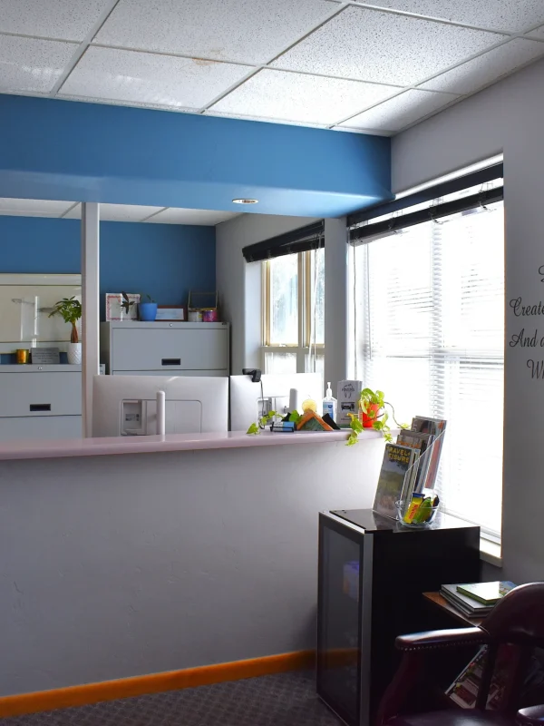 Rivers Dentistry reception area with blue accent wall and mission statement
