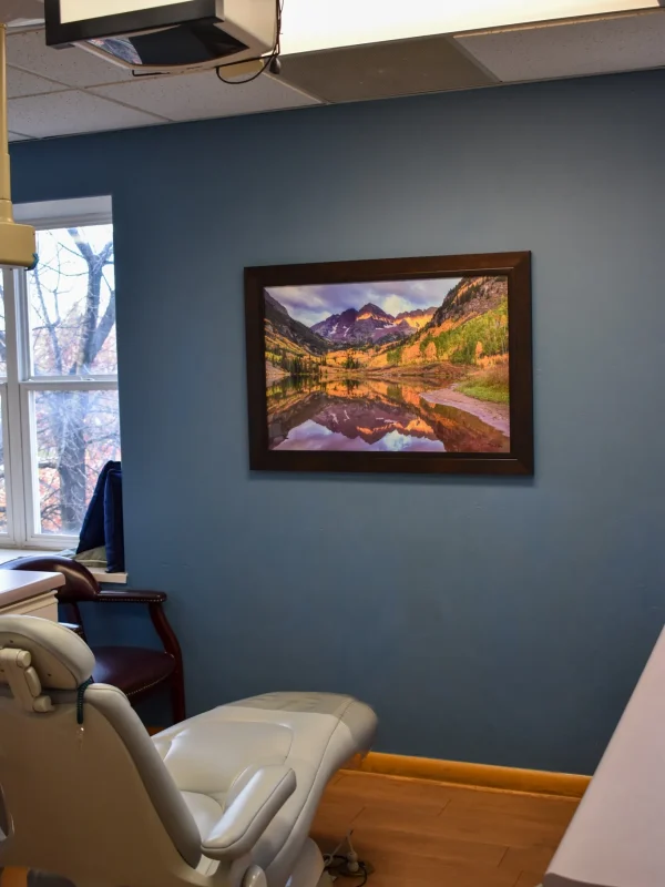 Rivers Dentistry treatment room with patient chair and landscape artwork